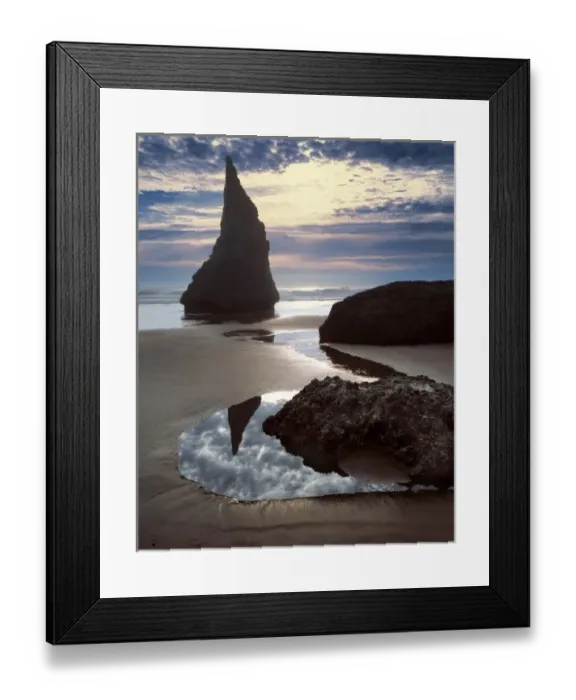 Framed Print : USA, Oregon, Face Rock Wayside. A thorn-shaped seastack is silhouetted against Framed Print : USA, Oregon, Face Rock Wayside. A thorn-shaped seastack is silhouetted against