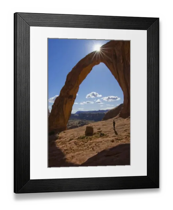 Framed Print : USA, Utah. A female hiker dwarfed by the Corona Arch near Moab. (MR) Framed Print : USA, Utah. A female hiker dwarfed by the Corona Arch near Moab. (MR)