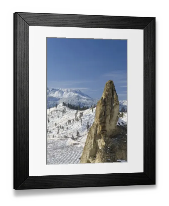 Framed Print : USA, Washington, Peshastin Pinnacles State Park. Jutting rock towers above wintry orchard
