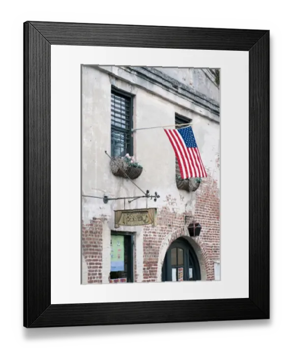 Framed Print : Charleston, South Carolina, USA. An American flag waves in the breeze outside a historic