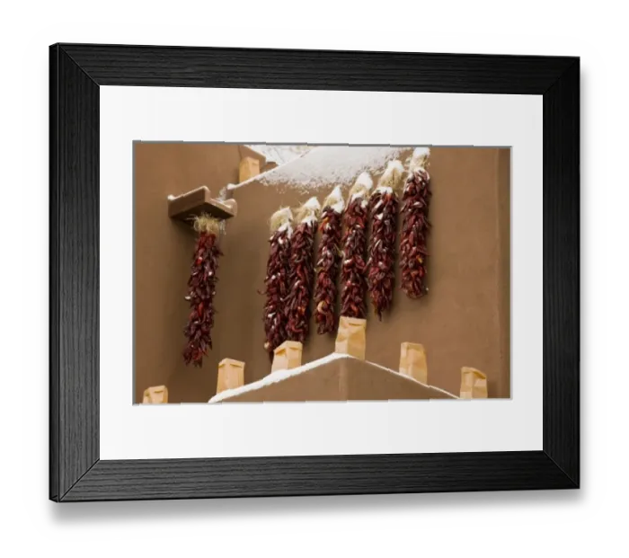 Framed Print : USA, New Mexico, Santa Fe. Close-up of chili pepper ristras hanging on snowy side of adobe building Framed Print : USA, New Mexico, Santa Fe. Close-up of chili pepper ristras hanging on snowy side of adobe building