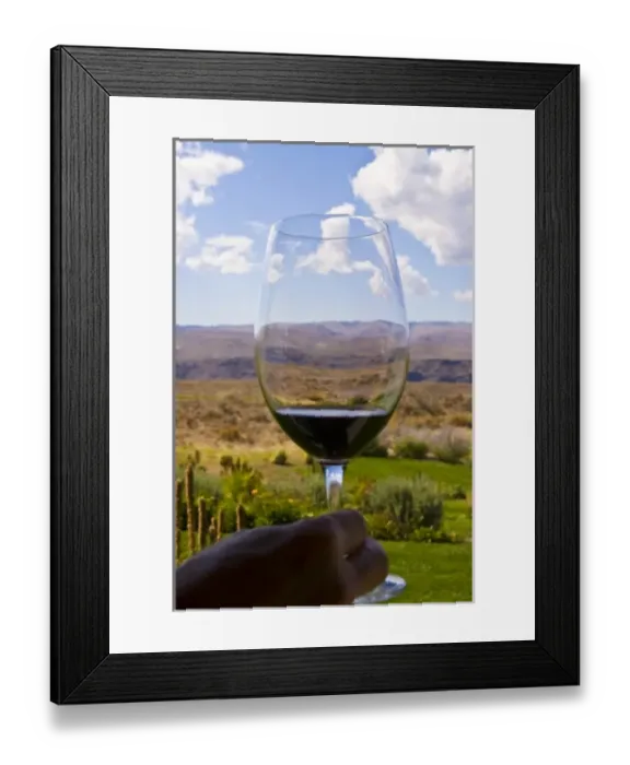 Framed Print : USA, Washington, Quincy. A sample of red wine in a glass overlooking Cave B Inn and Winery grounds Framed Print : USA, Washington, Quincy. A sample of red wine in a glass overlooking Cave B Inn and Winery grounds