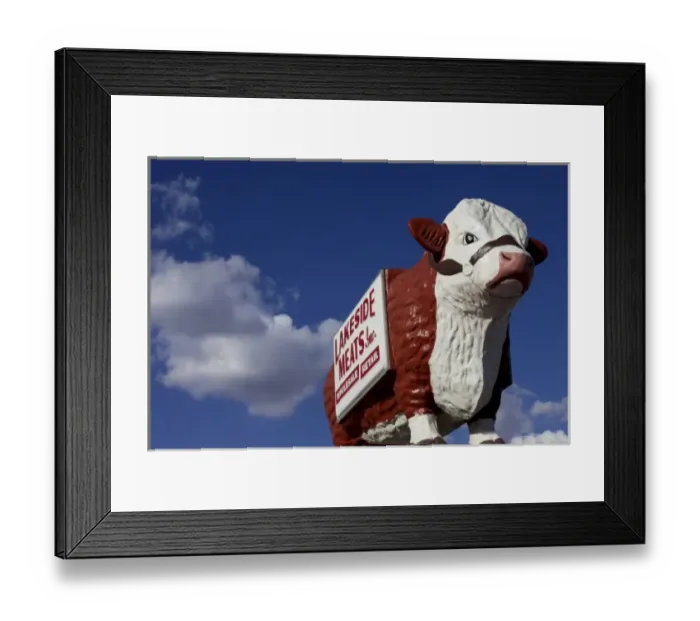 Framed Print : Carlsbad, New Mexico, United States. Vintage large cow sculpture atop meat market