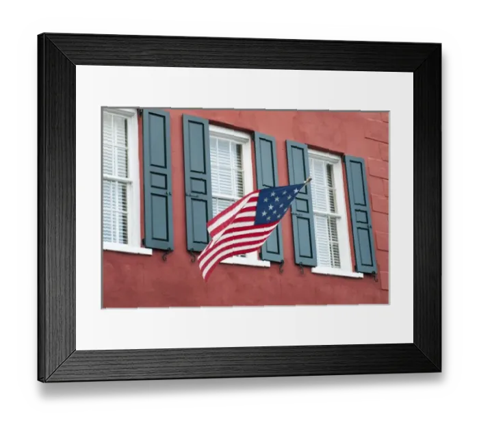 Framed Print : Charleston, South Carolina, USA. An Amerian flag flies over windows on a colorful Framed Print : Charleston, South Carolina, USA. An Amerian flag flies over windows on a colorful