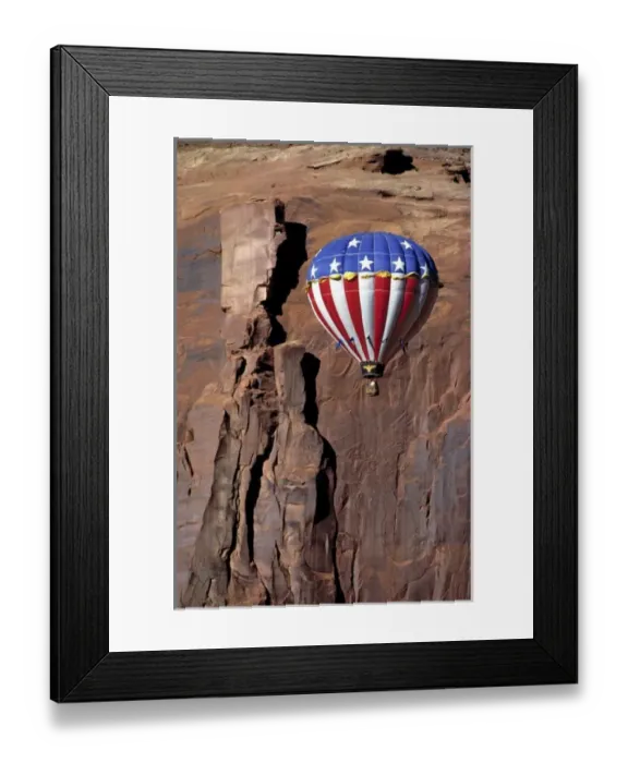Framed Print : USA, Utah, Monument Valley. A hot-air balloon floats against a rock wall in Monument Valley, Utah