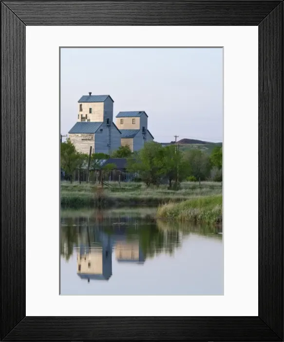 Framed Print : Pair of grain elevators reflect into pond at Sentinel Butte North Dakota