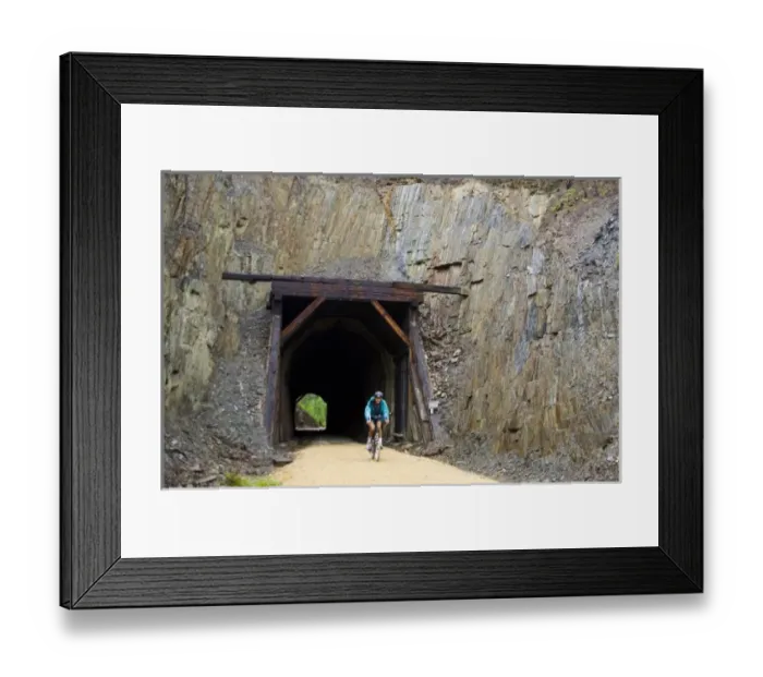 Framed Print : South Dakota. USA. Bicyclist & tunnel through slate along George S. Mickelson Trail Framed Print : South Dakota. USA. Bicyclist & tunnel through slate along George S. Mickelson Trail