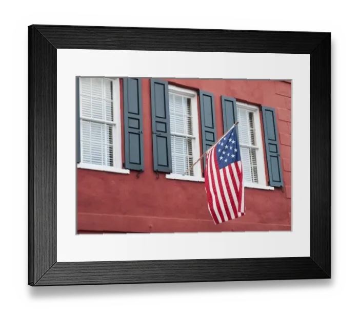 Framed Print : Charleston, South Carolina, USA. An Amerian flag flies over windows on a colorful Framed Print : Charleston, South Carolina, USA. An Amerian flag flies over windows on a colorful