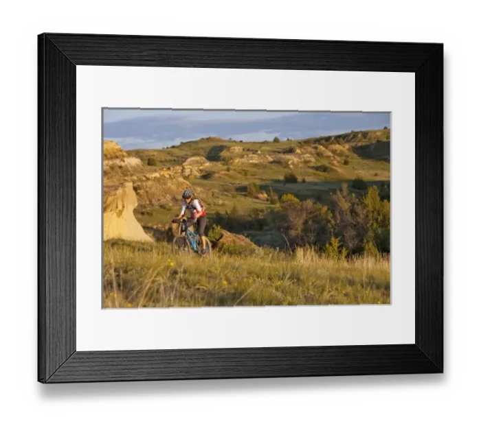 Framed Print : Woman mountain bikes on the Maah Daah Hey Trail near Medora North Dakota (MR)