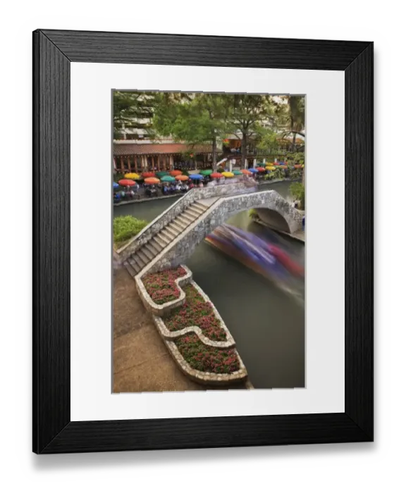 Framed Print : Outdoor cafe along River Walk and boat in motion passing under bridge over San Antonio River Framed Print : Outdoor cafe along River Walk and boat in motion passing under bridge over San Antonio River