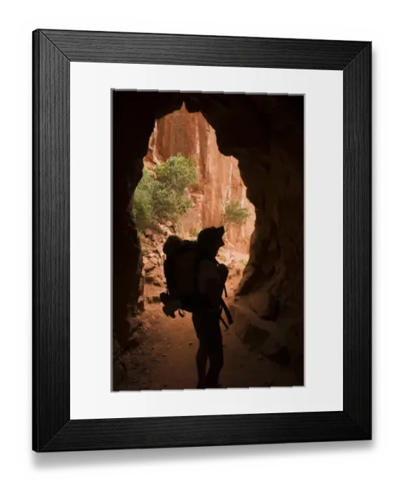 Framed Print : USA, Grand Canyon NP. A female backpacker passes through a tunnel while hiking below the North Rim
