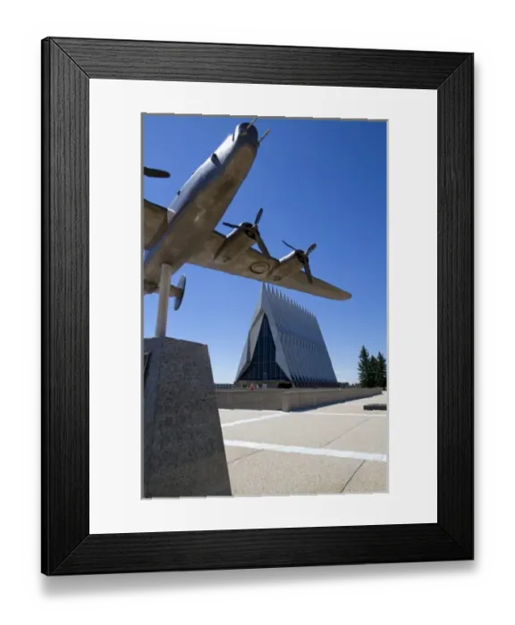 Framed Print : Bronze sculpure of vintage WW11 aircraft in front of the Cadet Chapel at the Air Framed Print : Bronze sculpure of vintage WW11 aircraft in front of the Cadet Chapel at the Air