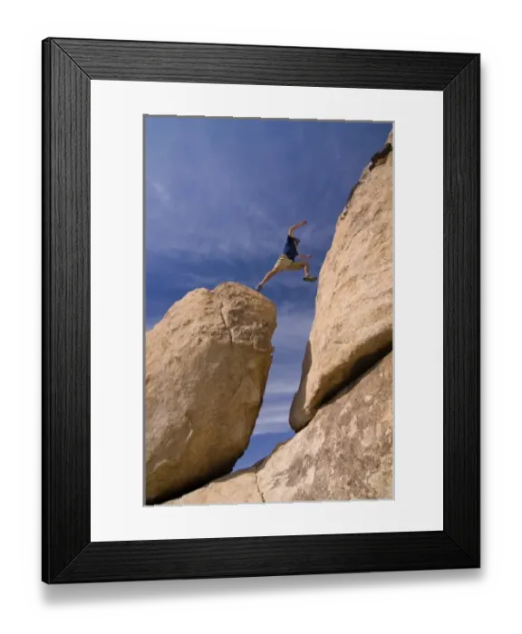 Framed Print : USA, California, Joshua Tree National Park. A male hiker boulder hopping. (MR)