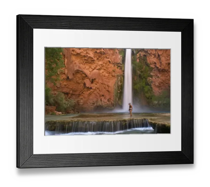Framed Print : USA, Arizona, Havasu Canyon. A bikini-clad woman wades through the creek below thundering