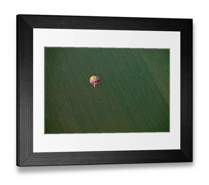 Framed Print : USA, Arizona, Val Vista. A brightly colored hot-air balloon soars above farmland Framed Print : USA, Arizona, Val Vista. A brightly colored hot-air balloon soars above farmland