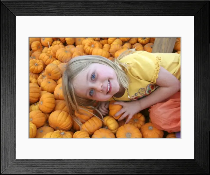Framed Print : USA, California, Encinitas. A young girl enjoys a local pumpkin patch carnival Framed Print : USA, California, Encinitas. A young girl enjoys a local pumpkin patch carnival