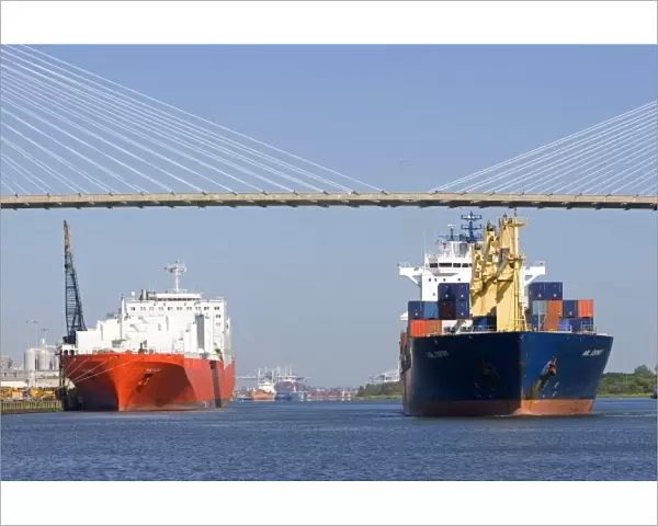 Container ships pass under the Talmadge Memorial Bridge at the Port of Savannah in Savannah