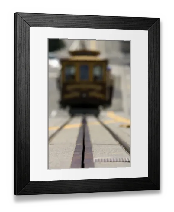 Framed Print : Ground level view of an approaching San Francisco cable car