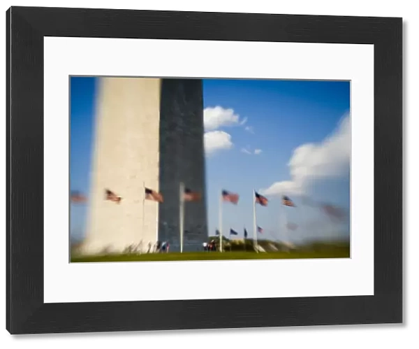 American flags next to Washington Monument (blurred), Washington D. C. (District of Columbia)