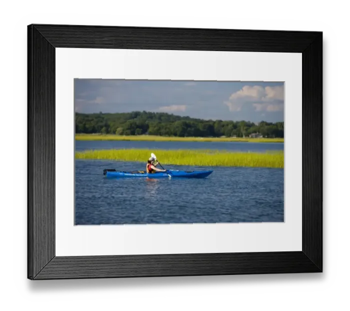 Framed Print : A woman kayaks near the mouth of the Connecticut River in Old Lyme, Connecticut