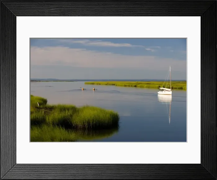 Framed Print : Kayakers paddle past a sailboat at anchor between Great Island and the shoreline