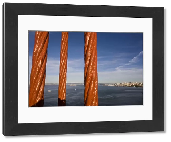 San Francisco and Alcatraz Island as seen through the cables of the Golden Gate Bridge