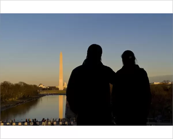 Couple looking over the pond, seeing the Washington Monument, Washington DC, USA (MR)