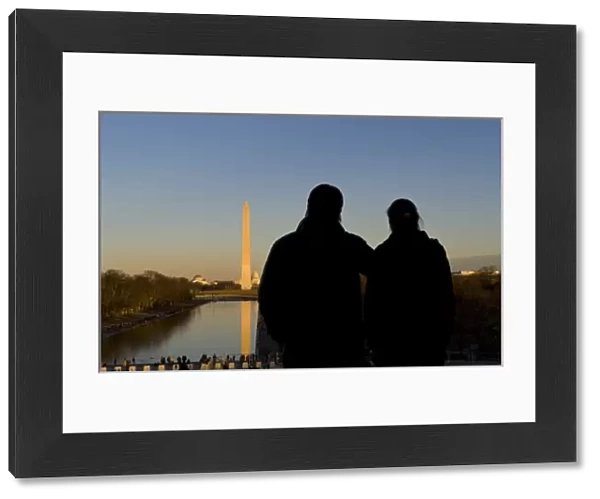 Couple looking over the pond, seeing the Washington Monument, Washington DC, USA (MR)