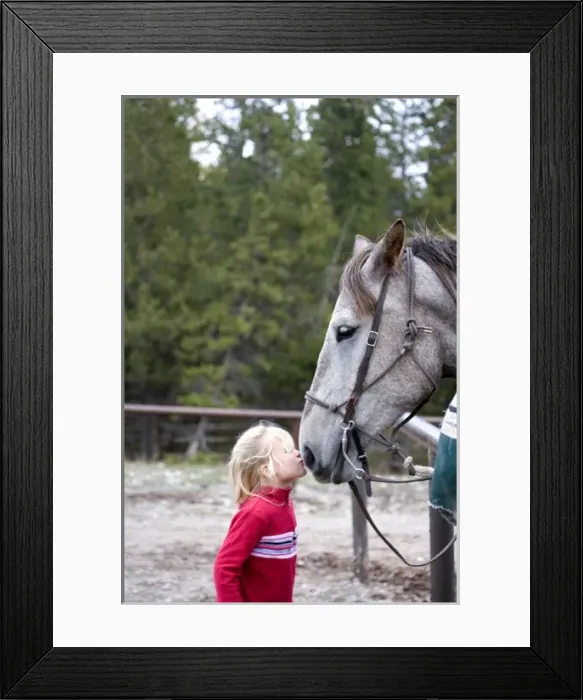 Framed Print : USA. Wyoming. Grand Tetons National Park. Girl kisses horse at a stable in the Tetons