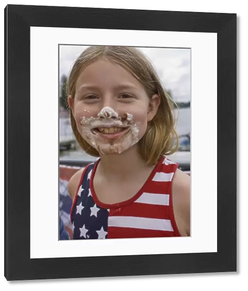 United States, Washington, Black Diamond, Girl (age 7) with pie on face, in American flag shirt