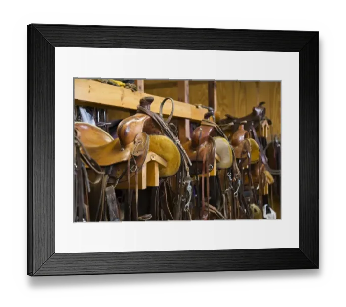 Framed Print : The tack room showing saddles and cowboy boots on The Hideout Ranch in Shell Wyoming
