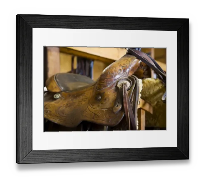 Framed Print : The tack room showing saddles and cowboy boots on The Hideout Ranch in Shell Wyoming