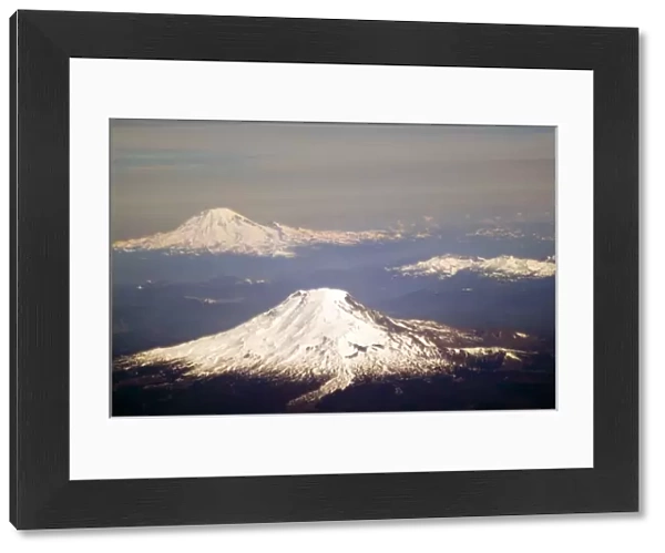 Aerial view of snow capped Mt. Adams and Mt. Rainier in the Washington Cascades