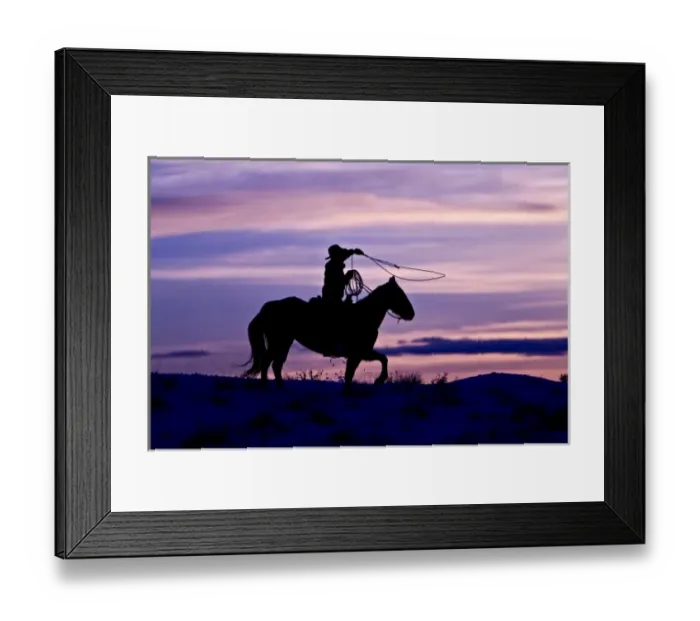 Framed Print : A silhouette of a cowboy on horses with the winter sky on The Hideout Ranch in Shell Wyoming