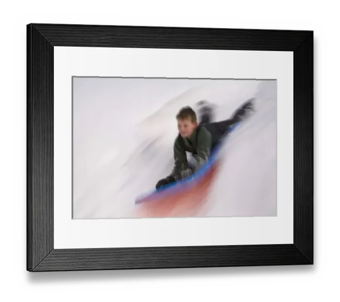 Framed Print : United States, Washington, Crystal Mountain, boy on sled in motion (MR) Framed Print : United States, Washington, Crystal Mountain, boy on sled in motion (MR)
