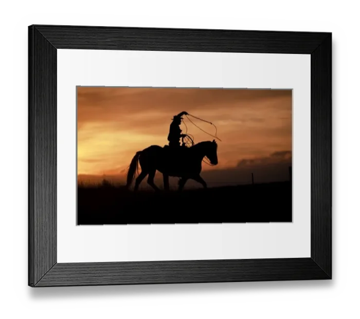 Framed Print : A silhouetted cowboy riding alone a ridge at sunset in Shell Wyoming Framed Print : A silhouetted cowboy riding alone a ridge at sunset in Shell Wyoming