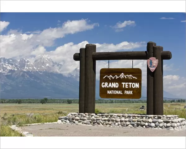 Grand Teton National Park welcome sign with the Grand Teton mountains in the background