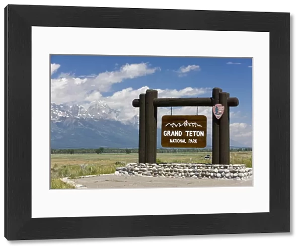 Grand Teton National Park welcome sign with the Grand Teton mountains in the background