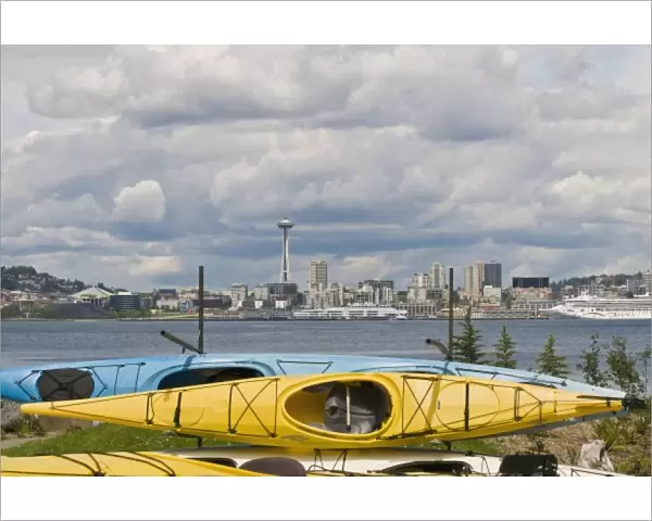 US, WA, Seattle. Kayaks on racks in West Seattle frame the downtown Seattle skyline