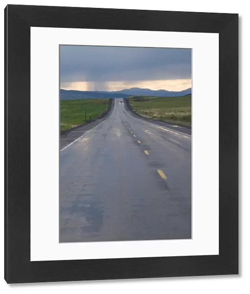 USA, Washington State. Storm clouds and rain ahead over the road in Central Washington