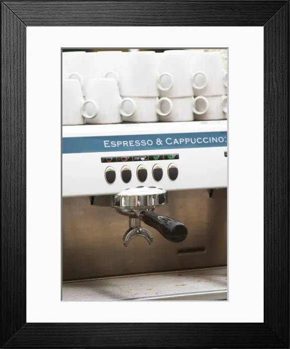 Framed Print : Espresso and Cappuccino machine, polished shining, with cups stacked on top. In a restaurant bar