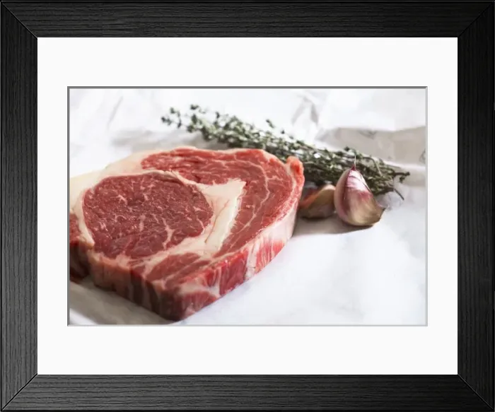 Framed Print : Stockholm, Sweden - Closeup image of a steak, cloves of garlic and fresh herbs