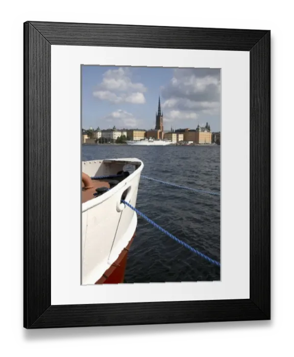 Framed Print : A boat in Sodermalm Island dock with Riddarholmen Island and the black spire of Riddarholmskyrkan Framed Print : A boat in Sodermalm Island dock with Riddarholmen Island and the black spire of Riddarholmskyrkan