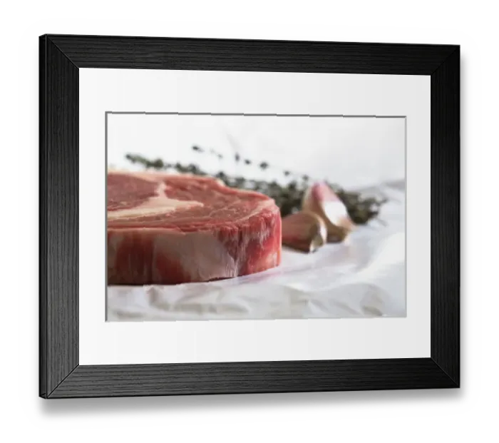 Framed Print : Stockholm, Sweden - Closeup, cropped image of a steak, cloves of garlic and fresh herbs