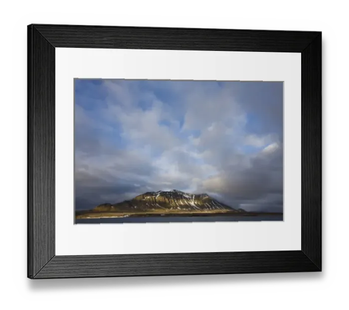 Framed Print : Norway, Svalbard, Spitsbergen Island, Setting sun lights clouds above eroded cliffs