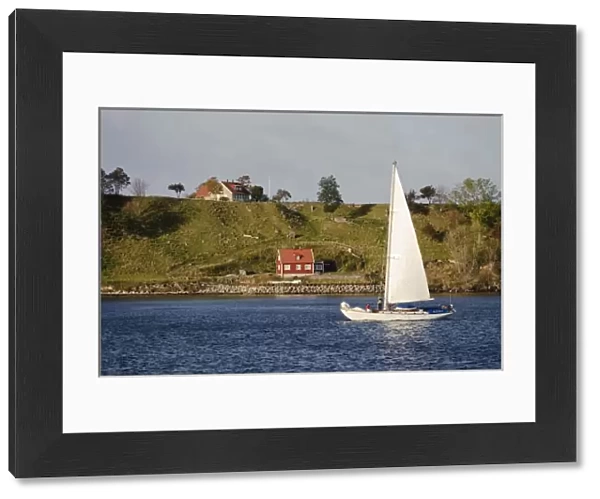 Sweden, Skane, Isle of Ven. Sailboat passing Isle of Ven. Sailing is a common activity in Oresund