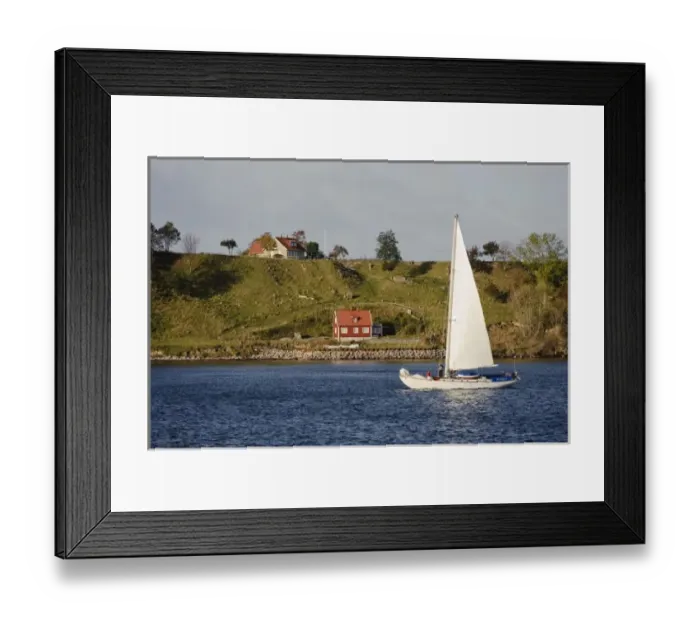 Framed Print : Sweden, Skane, Isle of Ven. Sailboat passing Isle of Ven. Sailing is a common activity in Oresund