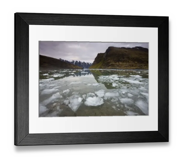 Framed Print : Norway, Svalbard, Spitsbergen, Small icebergs floating in fjord beneath mountain
