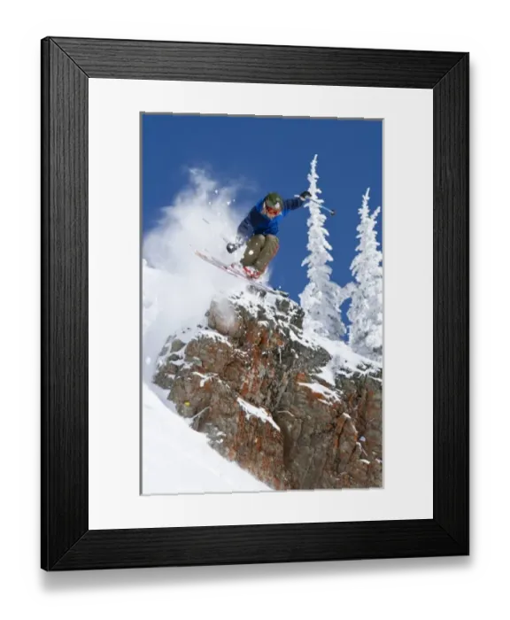 Framed Print : Man jumping colorful cliff and skiing in fresh powder at Whitefish Mountain Resort in Montana Framed Print : Man jumping colorful cliff and skiing in fresh powder at Whitefish Mountain Resort in Montana