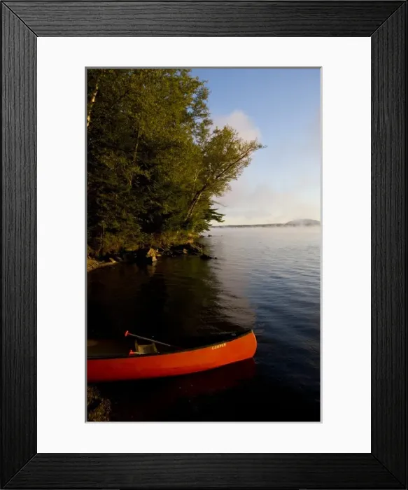 Framed Print : A canoe on shore in Lily Bay on Moosehead Lake Maine USA